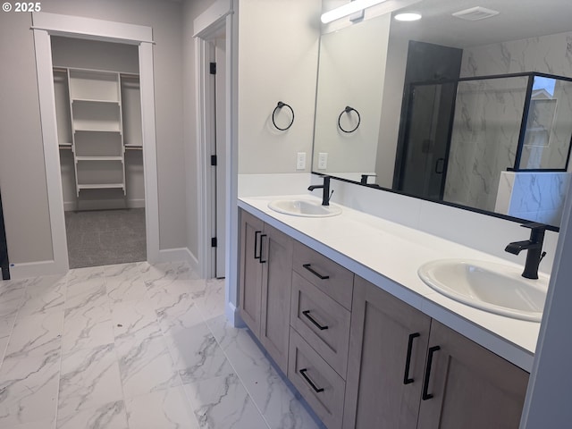 1006 NE 17th Ave, Canby, OR 97013 - full bathroom featuring marble look tile flooring, a marble finish shower, double vanity, baseboards, and a walk in closet