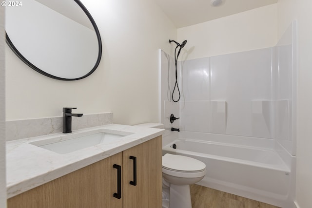 full bathroom featuring vanity, hardwood / wood-style flooring, toilet, and shower / bathtub combination