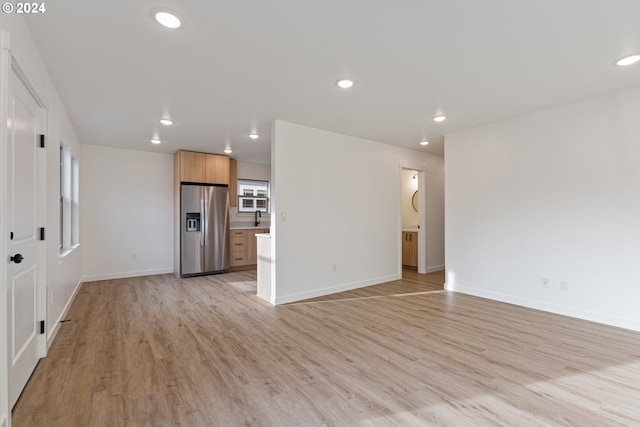 unfurnished living room featuring light hardwood / wood-style flooring