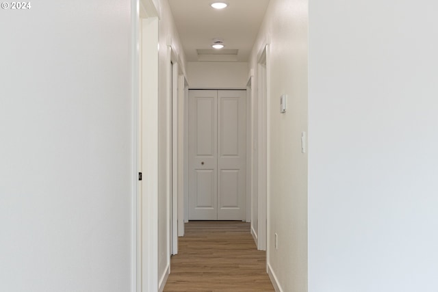 corridor with light hardwood / wood-style floors