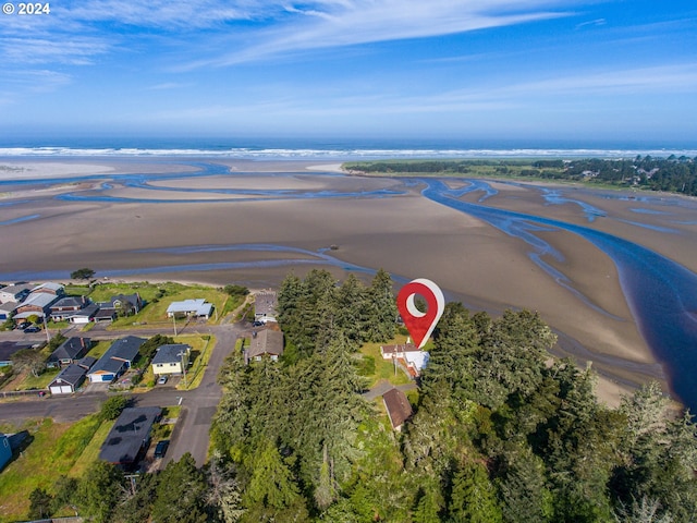 aerial view with a water view and a beach view