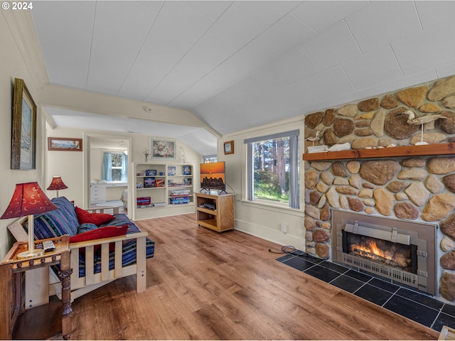 living room with a fireplace, hardwood / wood-style floors, and lofted ceiling