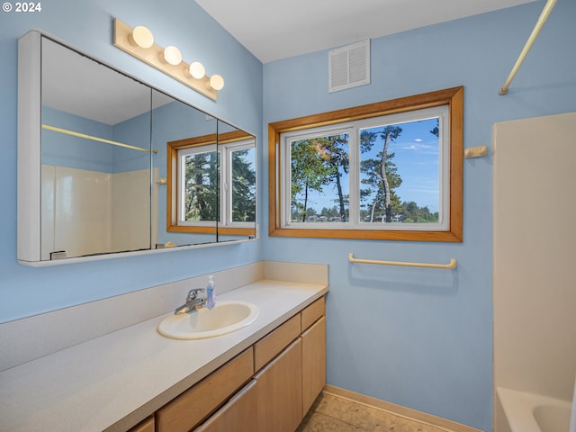 bathroom featuring shower / bathing tub combination, vanity, and tile patterned floors