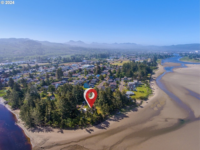 drone / aerial view with a water and mountain view