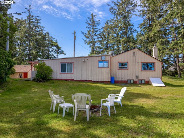 back of property featuring a lawn