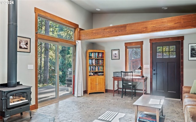 interior space featuring a wood stove and lofted ceiling