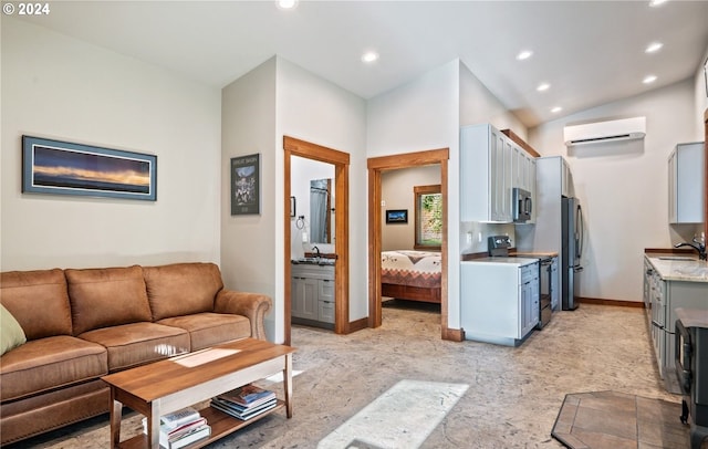 kitchen with gray cabinets, vaulted ceiling, sink, a wall mounted air conditioner, and appliances with stainless steel finishes