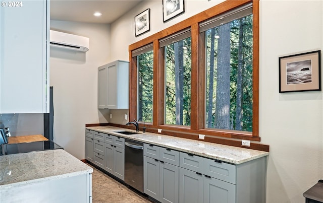 kitchen with dishwasher, light stone countertops, sink, and a wall mounted air conditioner