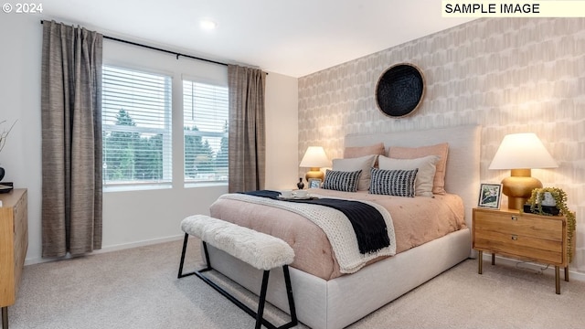 carpeted bedroom featuring multiple windows