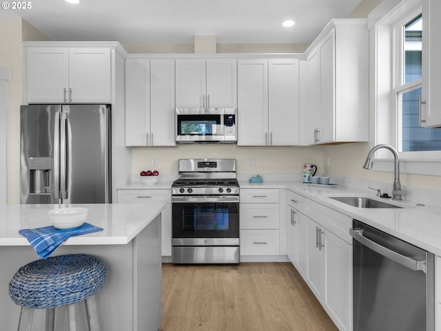 kitchen featuring white cabinets, recessed lighting, stainless steel appliances, and a sink