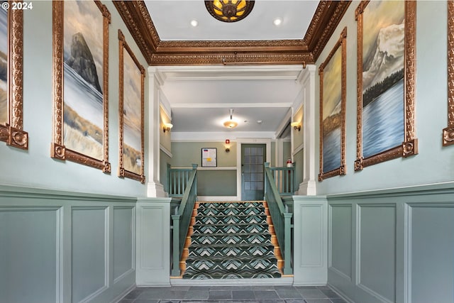 stairway with a decorative wall and crown molding