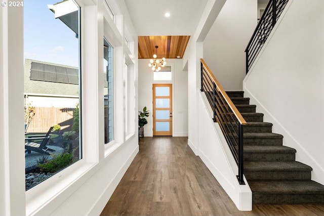 entrance foyer with hardwood / wood-style floors and a chandelier