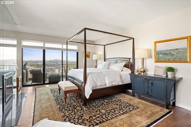 bedroom with dark wood-type flooring and access to outside