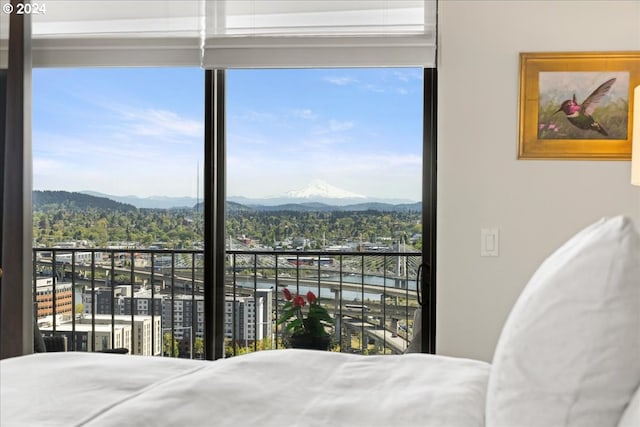 bedroom featuring a mountain view and multiple windows