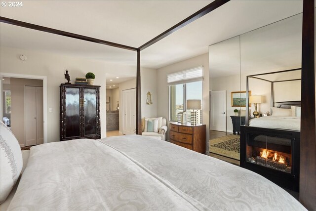 bedroom with hardwood / wood-style flooring and multiple windows