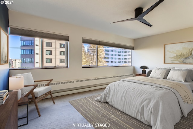 carpeted bedroom featuring radiator and ceiling fan