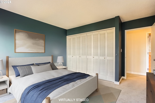 carpeted bedroom featuring a closet and a textured ceiling