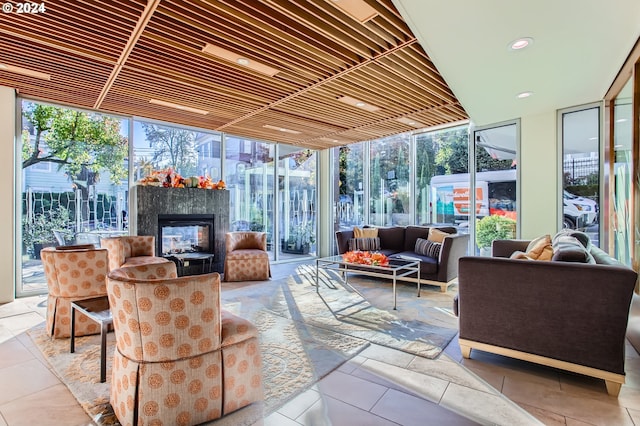 2323 SW Park Pl Unit 302, Portland, OR 97205 - sunroom / solarium featuring expansive windows, an outdoor living space with a fireplace, tile patterned flooring, and recessed lighting