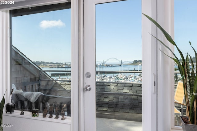 doorway with a healthy amount of sunlight and a water view