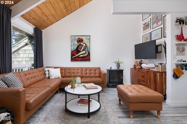 living room with high vaulted ceiling, hardwood / wood-style flooring, a wood stove, and wood ceiling