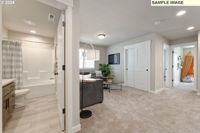 interior space with vanity, toilet, and shower / bathtub combination with curtain