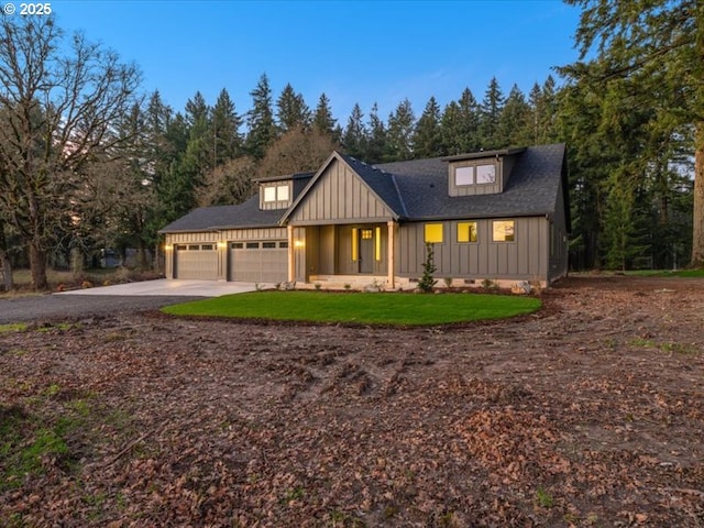 modern farmhouse style home with a garage and a front lawn