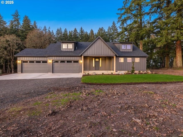 modern farmhouse style home featuring a front yard and a garage