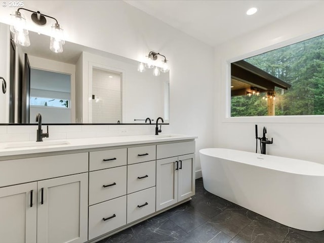 bathroom with vanity and a bathing tub