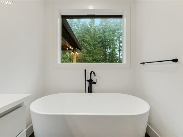 bathroom featuring a bath and vanity