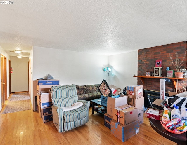 living room with a textured ceiling and light hardwood / wood-style flooring