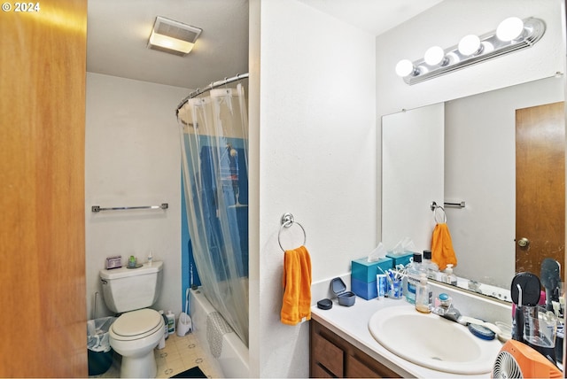 full bathroom with vanity, shower / tub combo, and toilet