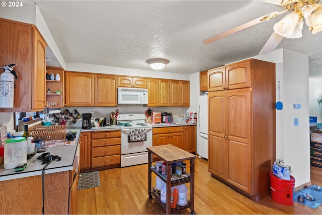 kitchen with a textured ceiling, ceiling fan, light hardwood / wood-style floors, and white appliances