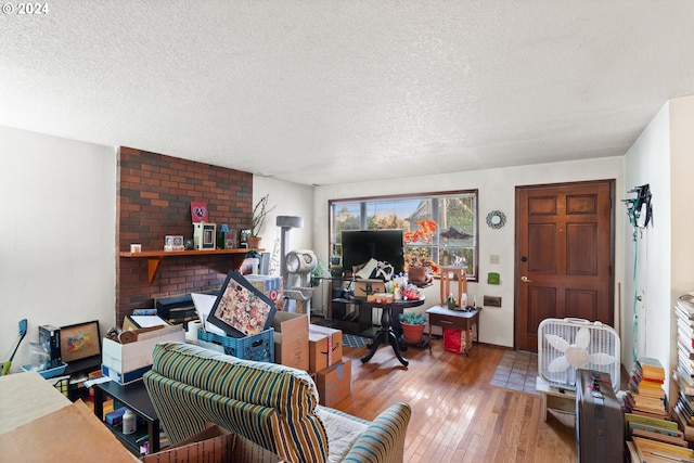 living room featuring a textured ceiling and light wood-type flooring