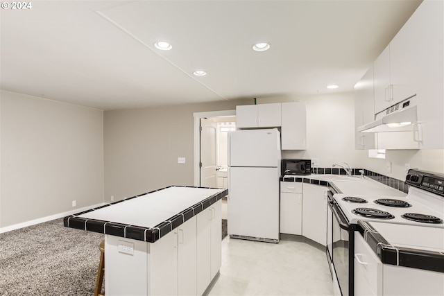 5108 NE Glisan St, Portland, OR 97213 - kitchen with freestanding refrigerator, electric range oven, under cabinet range hood, tile countertops, and recessed lighting