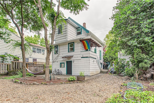 5108 NE Glisan St, Portland, OR 97213 - back of house with a chimney, fence, and a patio area