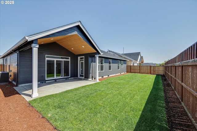 rear view of property with central AC unit, fence, and a patio area