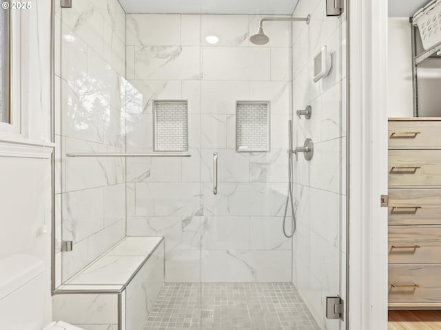 bathroom with toilet and walk in shower