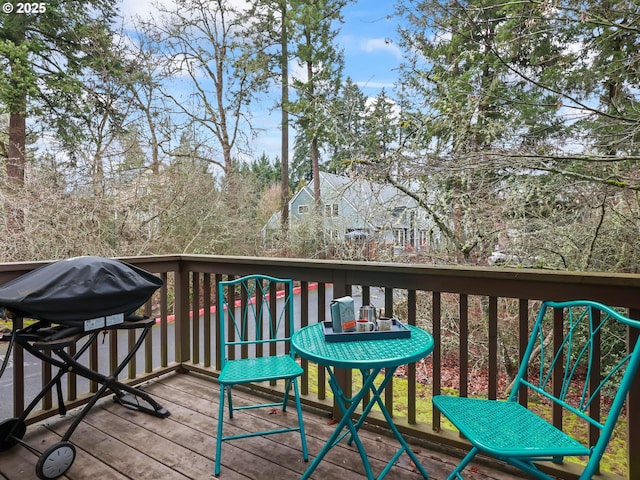 wooden terrace featuring a grill