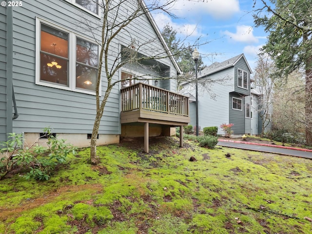 rear view of property with a wooden deck