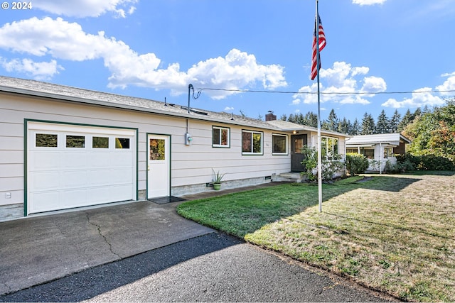 ranch-style home featuring a front yard and a garage