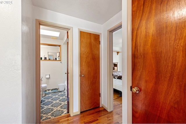 corridor with wood-type flooring