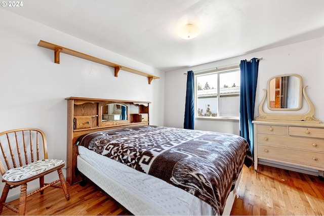 bedroom with hardwood / wood-style floors