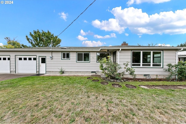 ranch-style house with a garage, a chimney, aphalt driveway, and a front yard