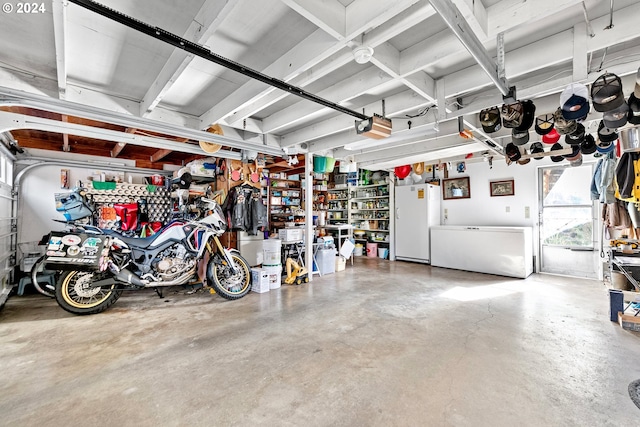 garage featuring a garage door opener and white fridge