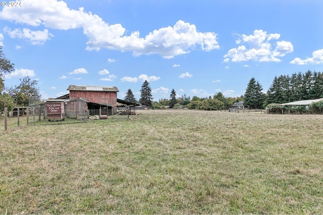 view of yard with a rural view and an outbuilding