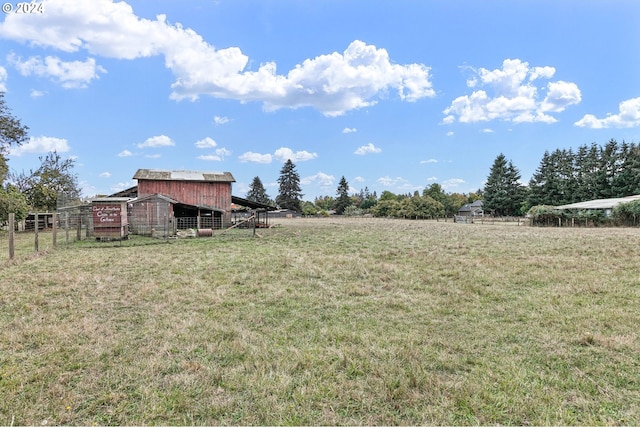 view of yard featuring an outdoor structure and fence
