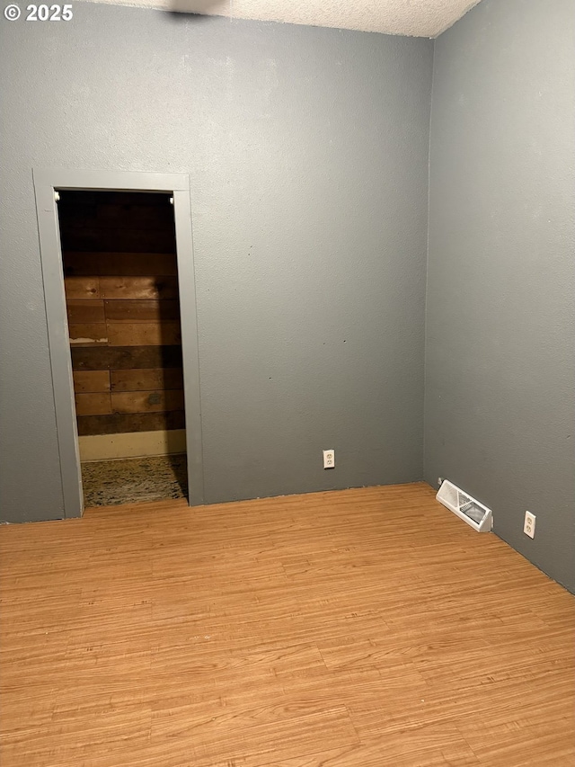 unfurnished room with light wood-type flooring