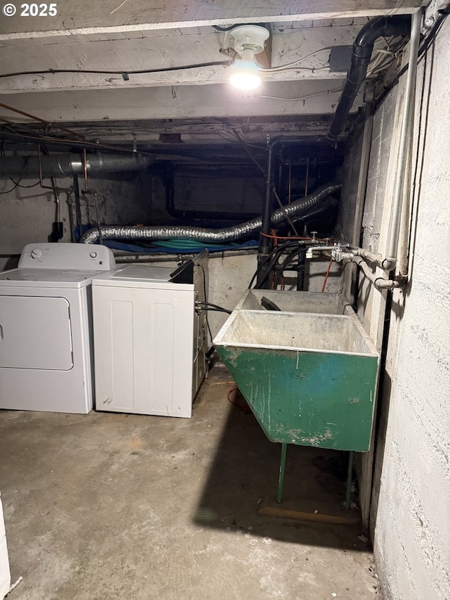 basement with separate washer and dryer and sink