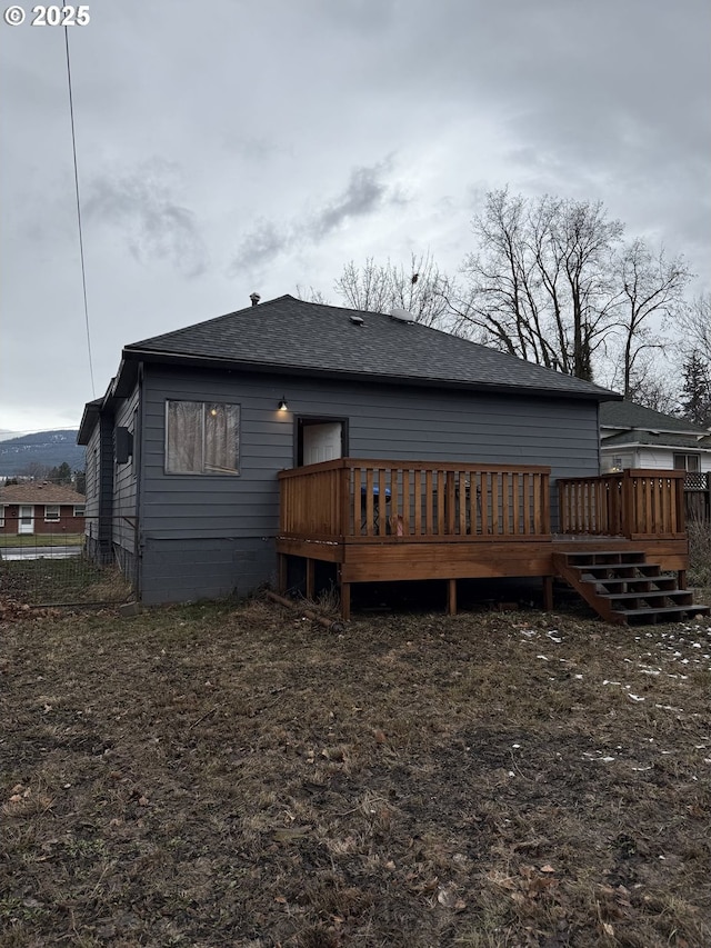 back of house with a deck