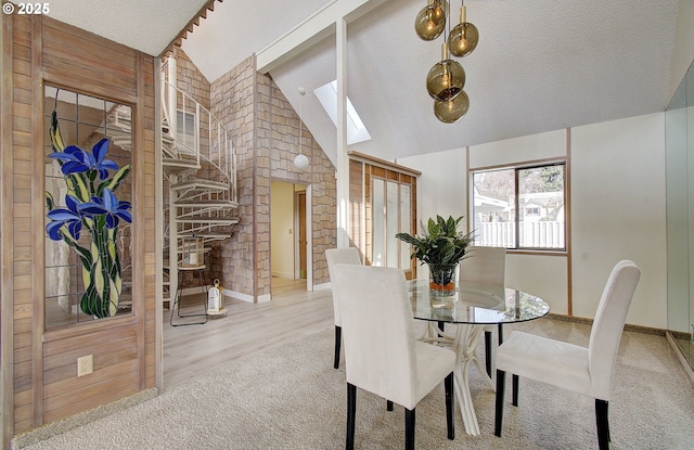 dining space with carpet flooring, a textured ceiling, baseboards, and vaulted ceiling